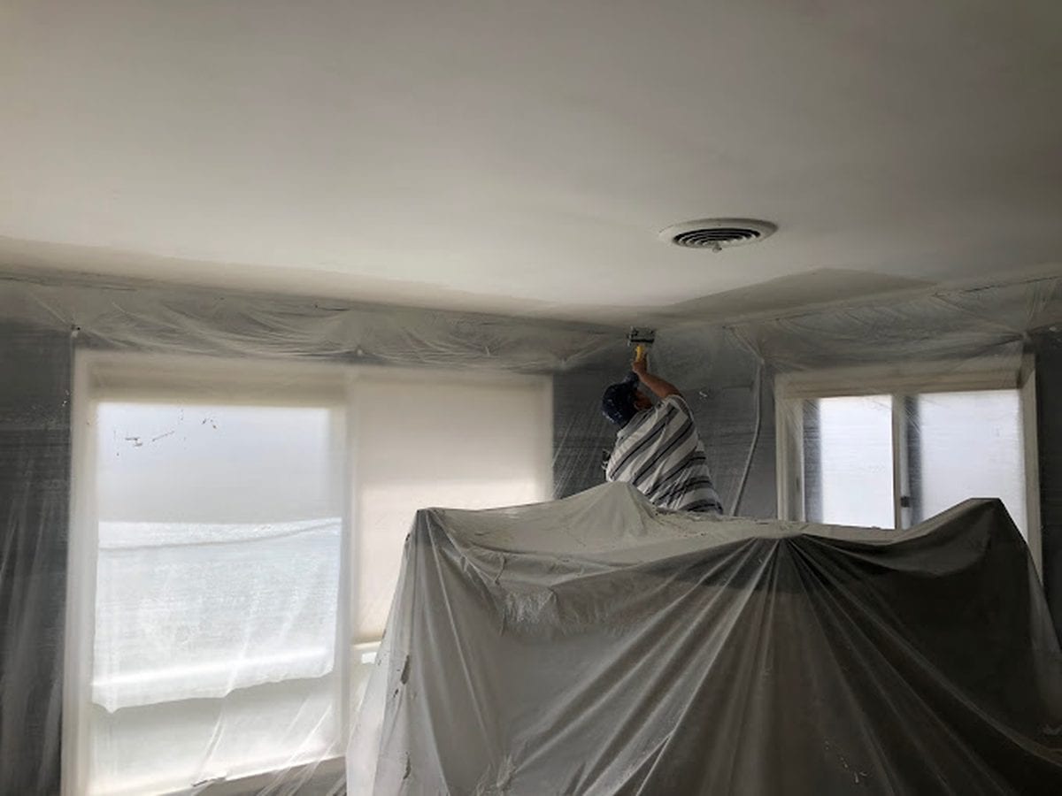 Room sheeted and masked for textured ceiling removal
