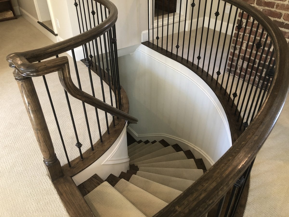 Curved staircase and landing after trim and wall repainting