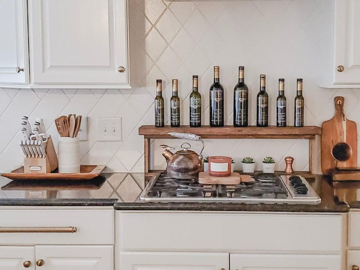 Custom kitchen with white painted cabinetry and a painted range hood