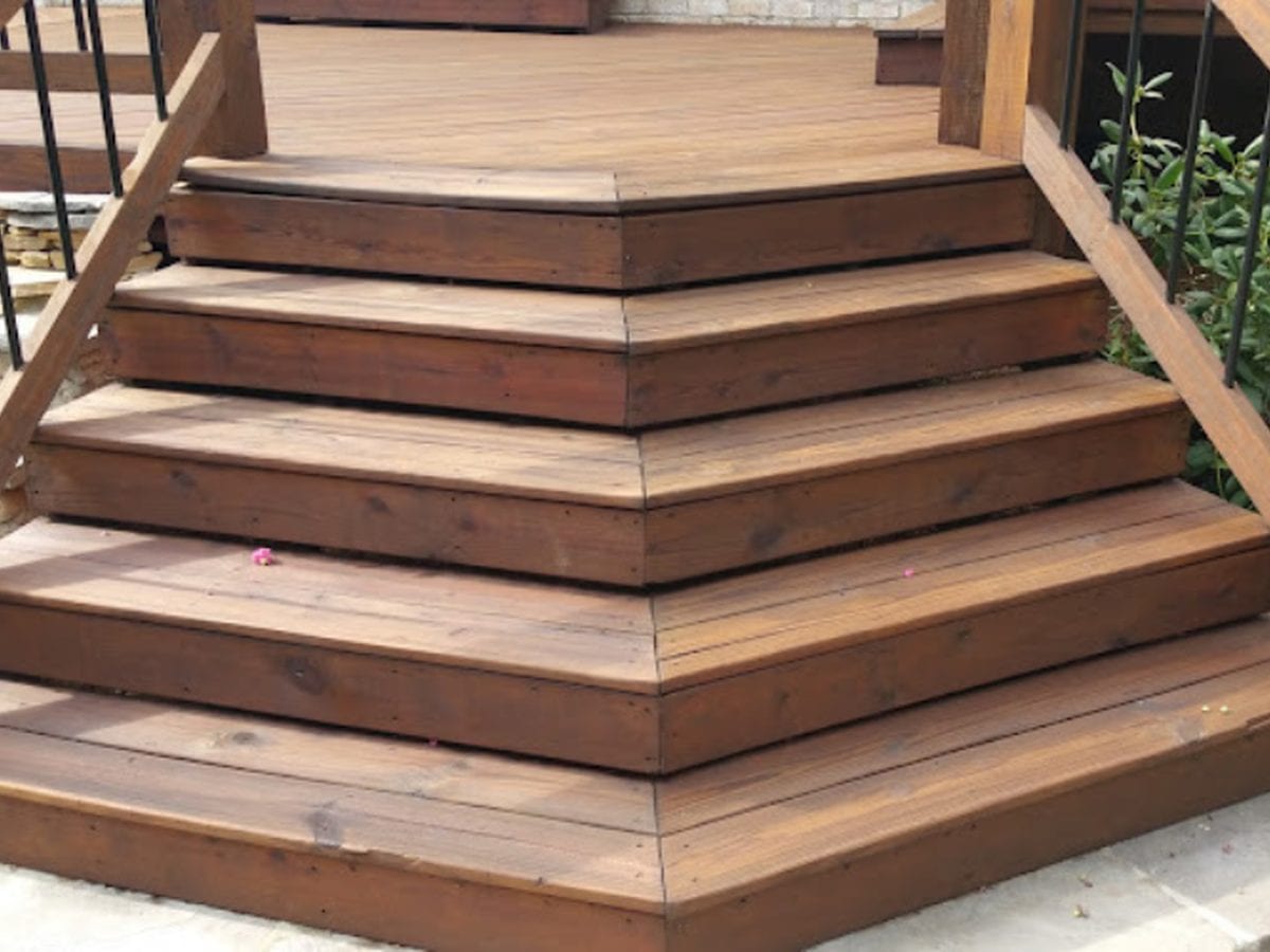 Wide wooden deck steps freshly stained a deep brown