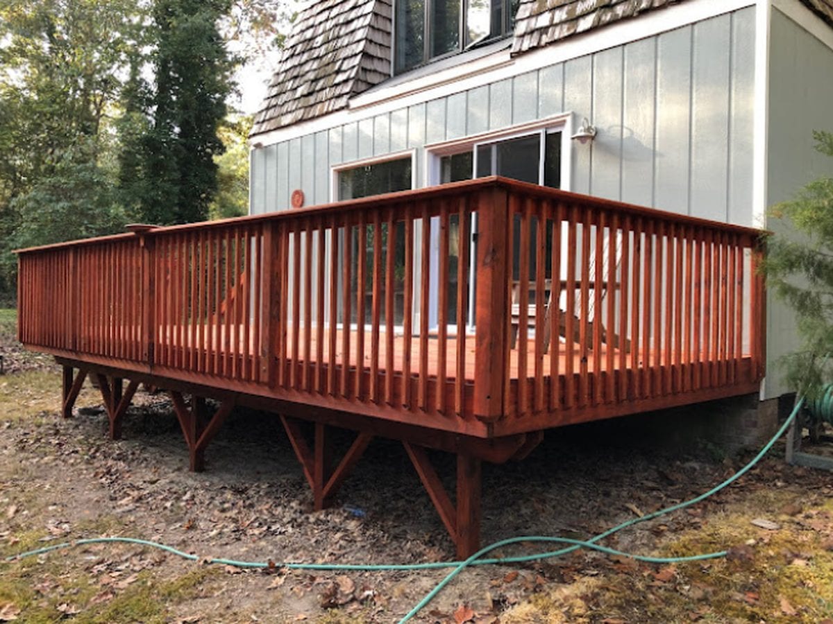 Large raised deck with railings after cleaning and staining