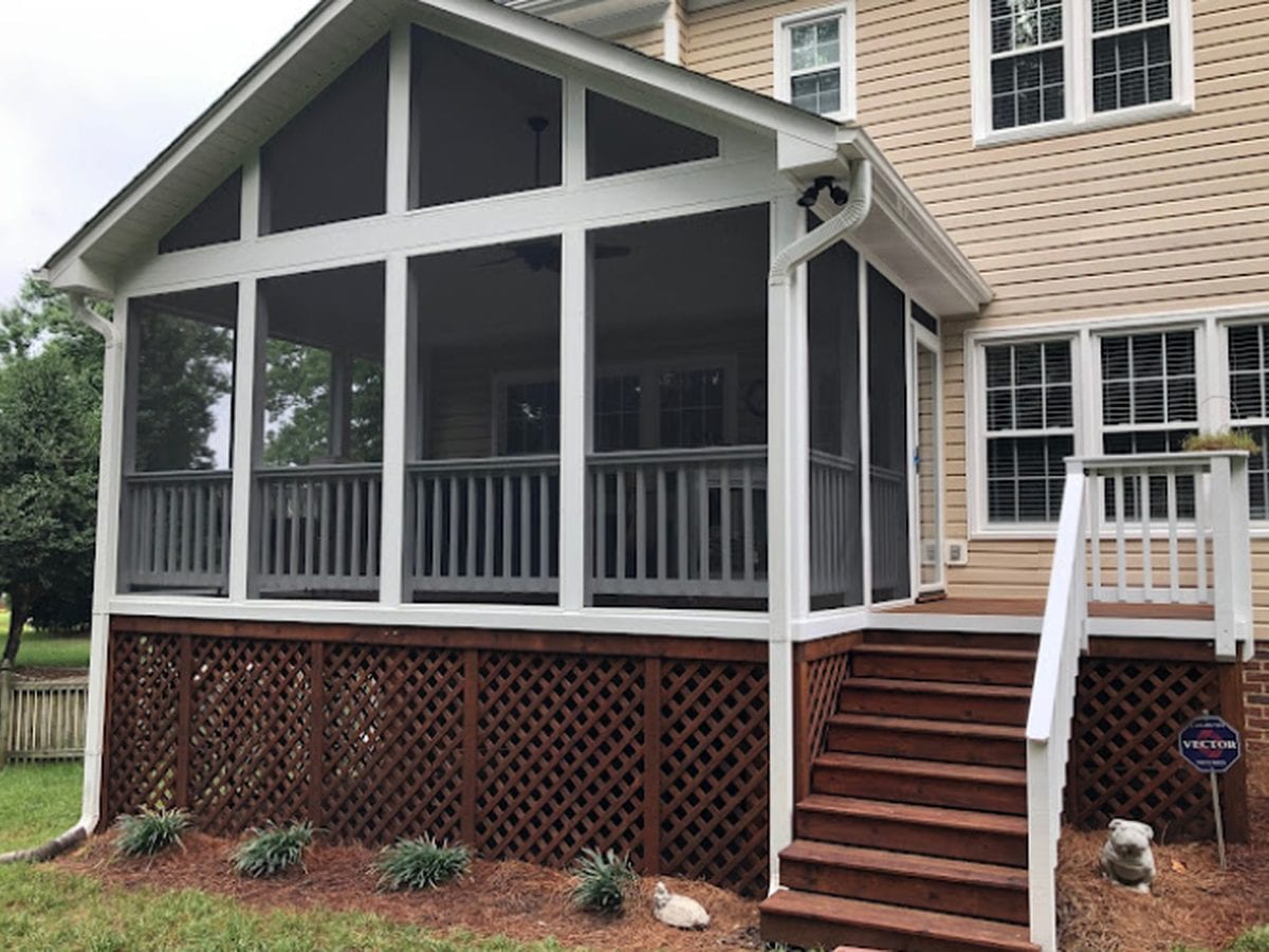 Screened porch with stained deck boards, steps and white painted posts